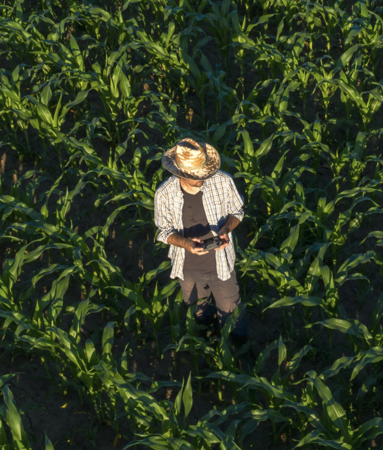 Main in a hat standing in a field